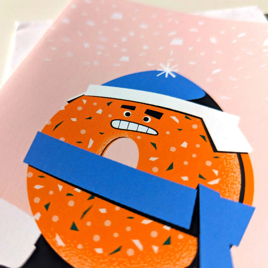 Cartoon donut character with a blue scarf on a pink background