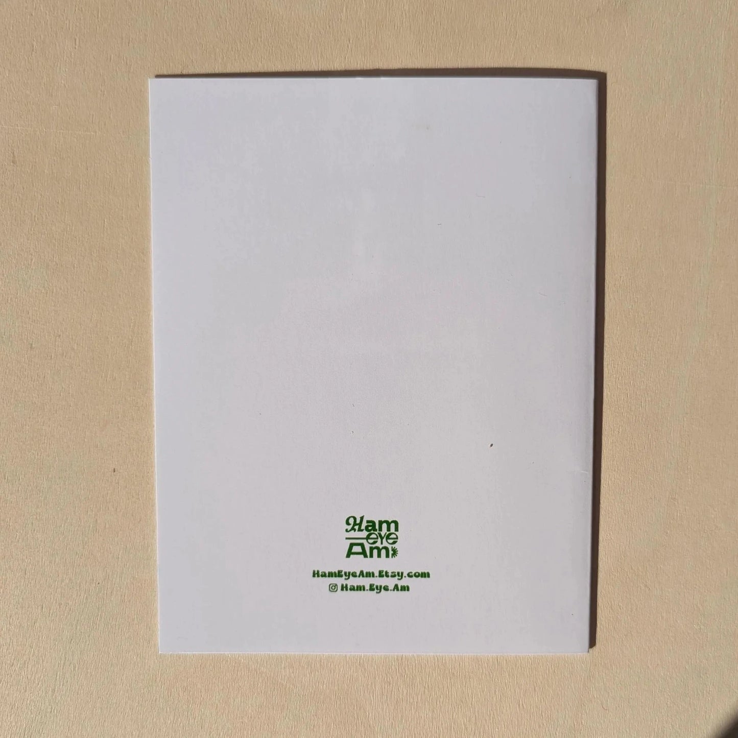 White card with green text on a beige background