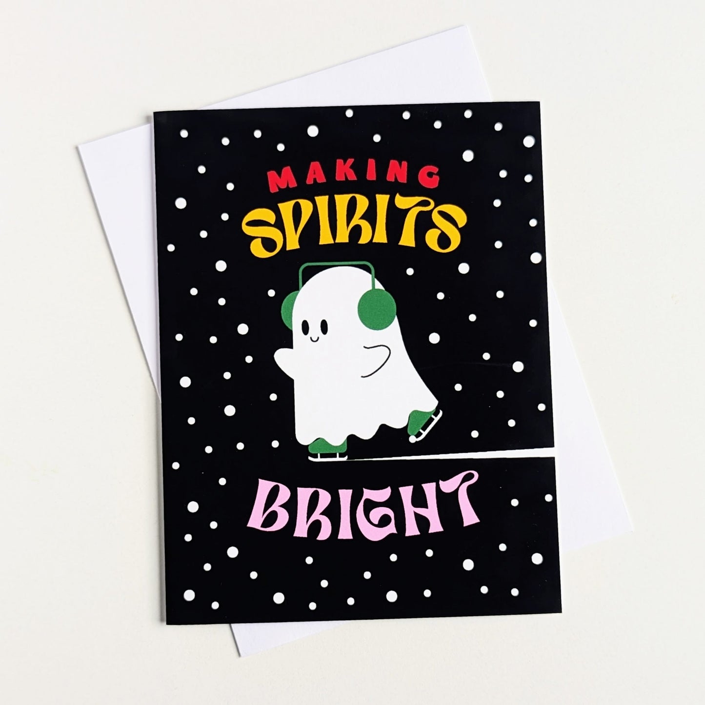 Greeting card with a ghost illustration and text 'Making Spirits Bright' on a black background with white polka dots.
