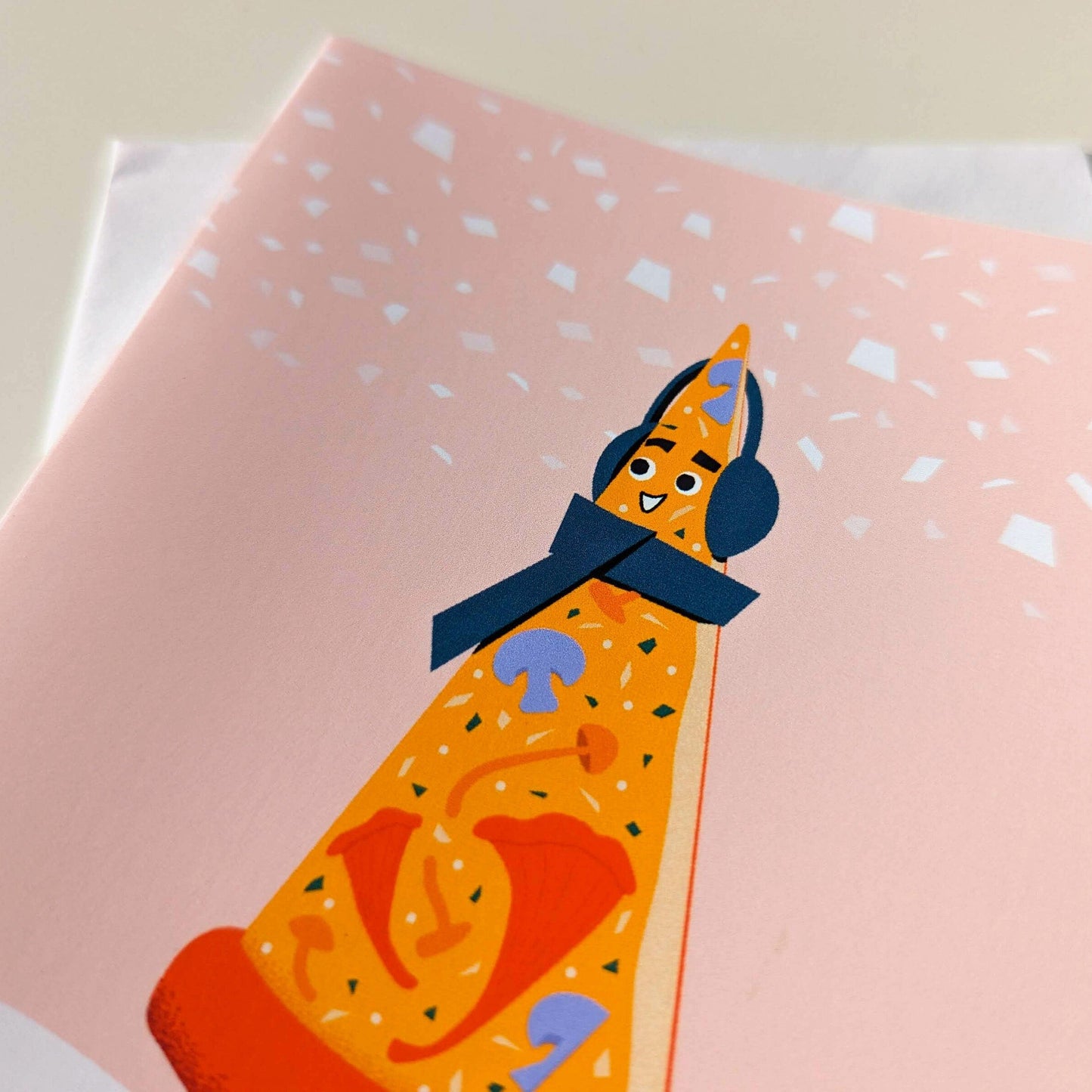 Notebook with a pizza character wearing headphones on a pink cover