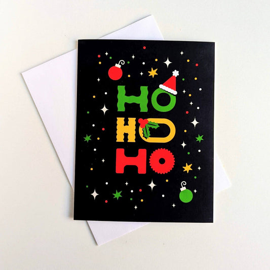 Black card with colorful 'HO HO HO' text and Christmas decorations on a white background