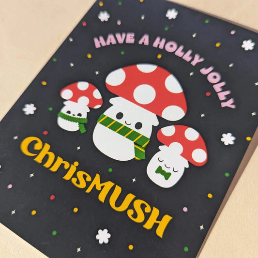 Christmas-themed card with cartoon mushrooms and text on a dark background