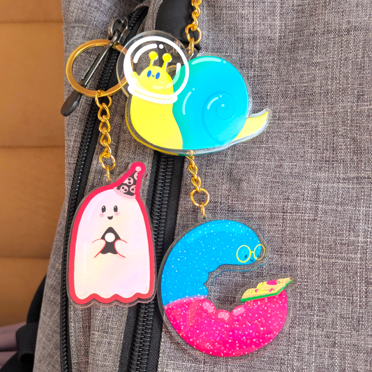Colorful keychains attached to a gray bag
